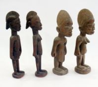 Two pairs of carved wooden Nigerian male