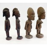 Two pairs of carved wooden Nigerian male