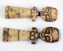 Two African carved bone female figures,