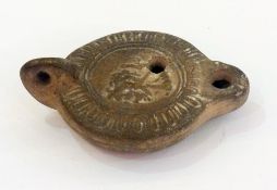 Roman earthenware oil lamp with embossed