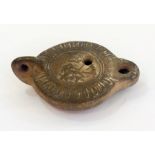 Roman earthenware oil lamp with embossed