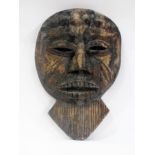African carved hardwood mask having bead