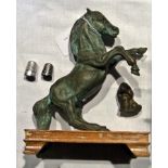 A bronzed metal model of a horse with a