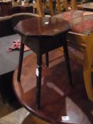 Stained wood circular table on quadruple