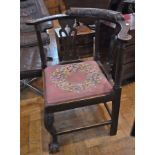 Carved oak corner chair with scroll carv