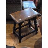 Reproduction oak stool with carved and i