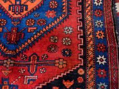 Persian wool rug with central orange geo