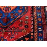 Persian wool rug with central orange geo