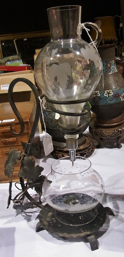 A metal and glass wine filter with engra