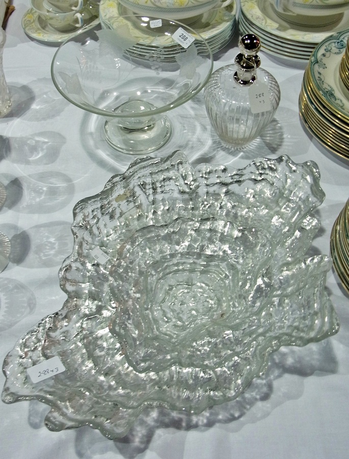 A glass fruit bowl, a glass decanter and