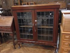 Polished wood display cabinet enclosed b