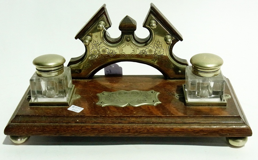 An Edwardian wooden ink stand with a pla