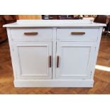 An old white painted kitchen cupboard wi