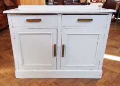 An old white painted kitchen cupboard wi