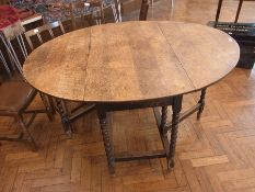An old global topped oak gateleg table,