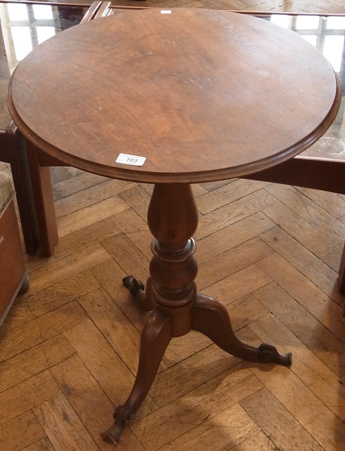 A walnut circular top tripod table with