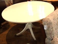A white painted circular top dining tabl