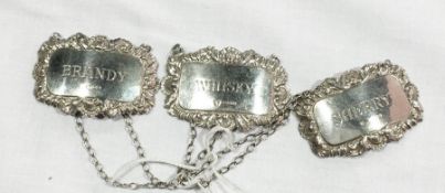 Three silver decanter labels with shell