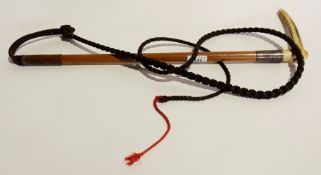 A hunting whip with bone handle and a ca