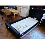 A modern single bed with faux leather he