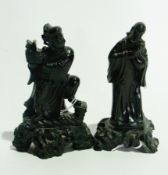 Two carved polished black stone Oriental