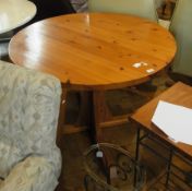 A modern pine circular top dining table