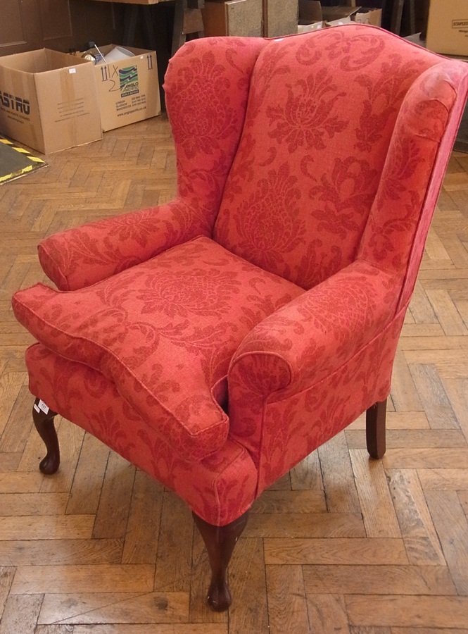 Wing armchair upholstered in red printed