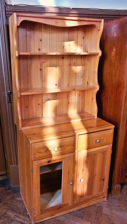 A modern pine dresser with a two shelf o