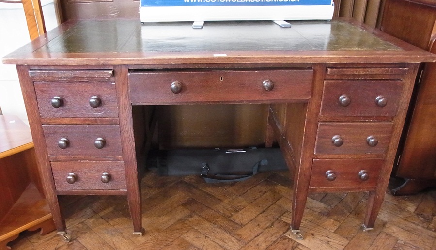 An early 20th century oak kneehole desk,