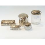 A set of silver capped glass dressing ta