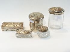 A set of silver capped glass dressing ta