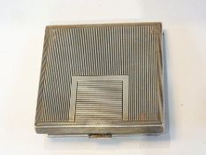 A lady's square silver compact with reed