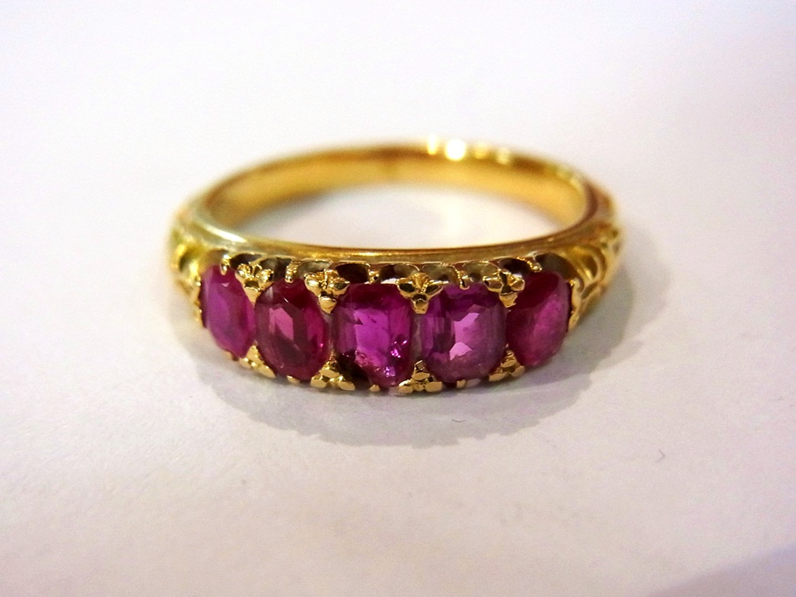Gold and ruby five-stone ring