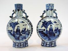 Pair of Chinese blue and white moon flasks depicting woman and boy next to a palm tree in the