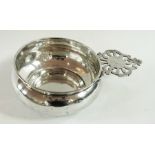 A white metal porringer with pierced fre