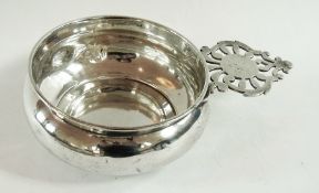 A white metal porringer with pierced fre