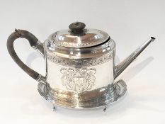 A George III silver teapot of oval form
