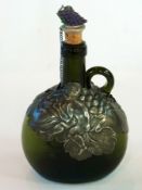 An Art Nouveau green glass wine bottle w