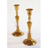 A pair of Georgian brass candlesticks of