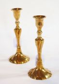 A pair of Georgian brass candlesticks of