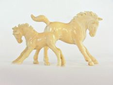 Carved ivory models of horse and foal, h