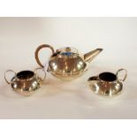 A silver plate teapot of compressed form