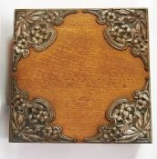 An Edwardian Art Nouveau oak and silver-