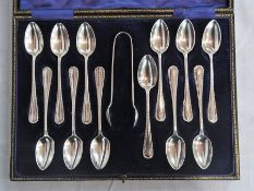 A set of twelve silver teaspoons and a p