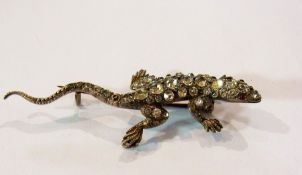 Silver brooch of a lizard inset with whi