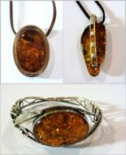 Amber pendant, white metal mounted, on b