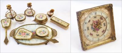 Gilt metal and tapestry dressing table set viz:- clock, pair candle holders, brushes, tray, pots,