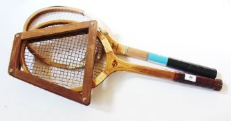 Two wooden tennis racquets and badminton