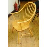 A set of six Ercol hoop and stickback arm chairs with crinoline stretchers