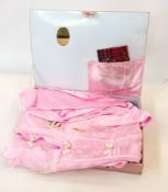 A pink satin 1950's pyjama set with matc